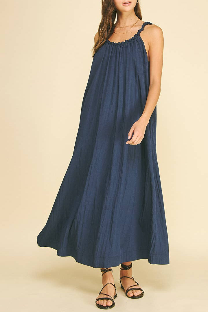 Woman wearing a blue dress against a beige background